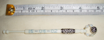 silver wrapped and inscribed bone bobbin